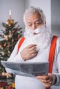 Santa claus reading newspaper Royalty Free Stock Photo