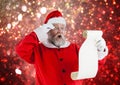 Santa claus reading wish list Royalty Free Stock Photo