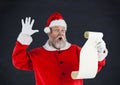 Santa claus reading a wish list Royalty Free Stock Photo