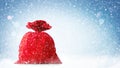 Santa Claus red bag full, on blue background with snow. Royalty Free Stock Photo