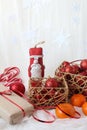 Santa Claus with red Christmas balloons and tangerines on a white background, close-up, space for text, vertical frame Royalty Free Stock Photo