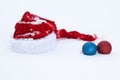 Santa Claus red hat with balls on white snow Royalty Free Stock Photo