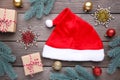 Santa Claus red hat and gifts on grey background. Christmas decoration Royalty Free Stock Photo