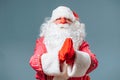 Santa Claus red nose blue  looking at camera hand hold gesture of gratitude in front of him. Royalty Free Stock Photo