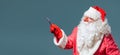 Santa Claus with red nose side view stand on right show to the left with a pointer. Royalty Free Stock Photo