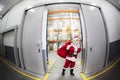 Santa Claus + red sack leaving storehouse of gifts Royalty Free Stock Photo