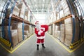 Santa Claus + red sack in storehouse of presents Royalty Free Stock Photo