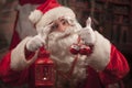 Santa Claus holding christmas lantern and decorations Royalty Free Stock Photo