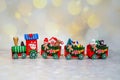 Santa Claus red toy train on background of golden bokeh. Selective focus. Christmas greeting card Royalty Free Stock Photo