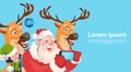 Santa Claus With Reindeer Elfs Making Selfie Photo, New Year Christmas Holiday Greeting Card Royalty Free Stock Photo