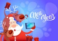 Santa Claus With Reindeer Making Selfie Photo, New Year Christmas Holiday Greeting Card Royalty Free Stock Photo