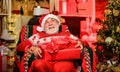 Santa Claus relaxing in arm chair. Bearded senior man Santa Claus. Legend about Santa Claus. Merry christmas. Delivering Royalty Free Stock Photo