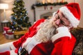 Santa claus relaxing on sofa in living room at home Royalty Free Stock Photo