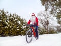 Santa Claus rides a bicycle in winter Royalty Free Stock Photo