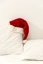 Santa Claus's hat is lying on the bed