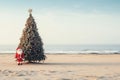 Santa Claus at sea beach with decorated christmas tree happy new year concept Royalty Free Stock Photo