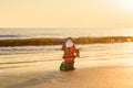 Santa Claus on sea beach. Happy New Year and merry Christmas travel, tropical vacations concept. Royalty Free Stock Photo