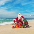 Santa Claus at sea beach with many gifts and decorated christmas Royalty Free Stock Photo