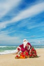 Santa Claus at sea beach with many gifts and decorated christmas Royalty Free Stock Photo
