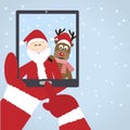 Santa Claus selfie with reindeer Royalty Free Stock Photo