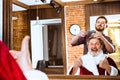 Santa claus shaving his personal barber Royalty Free Stock Photo