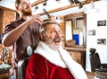 Santa claus shaving his personal barber