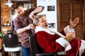 Santa claus shaving his personal barber Royalty Free Stock Photo