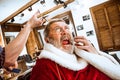 Santa claus shaving his personal barber Royalty Free Stock Photo