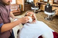 Santa claus shaving his personal barber Royalty Free Stock Photo