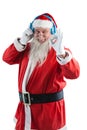 Santa claus showing hand okay sign while listening to music on headphones Royalty Free Stock Photo