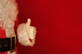 Santa Claus showing ok sign over red background