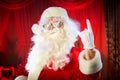 Santa Claus shows a hand a heavy rock symbol.