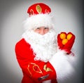 Santa Claus shows heart.