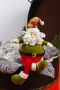 Santa Claus sits on vintage brouwn coffer with white christmas t