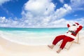 Santa Claus sitting on beach chairs. Christmas holiday concept. Royalty Free Stock Photo