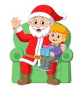 Santa claus sitting in chair with a little cute boy Royalty Free Stock Photo