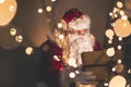 Santa Claus opening glowing gift box