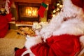 Santa Claus sitting and enjoying in cookies and milk Royalty Free Stock Photo
