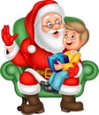 Santa Claus sitting with a little cute boy Royalty Free Stock Photo