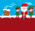 Santa Claus sitting with two elves on roof house Royalty Free Stock Photo