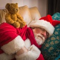 Santa Claus is tired, sleeping on the couch. Santa Claus is difficult job Royalty Free Stock Photo