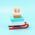 Santa claus sleigh with gift boxes on blue background. Minimal Christmas concept Royalty Free Stock Photo