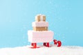 Santa claus sleigh with gift boxes under snowfall on blue background. Minimal New Year concept Royalty Free Stock Photo