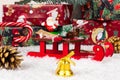 Santa claus on sleigh, lollipop staff, boxes with gifts, christmas tree cone and golden bell on a background of snow Royalty Free Stock Photo