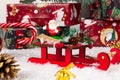 Santa claus on sleigh, lollipop staff, boxes with gifts, christmas tree cone and golden bell on a background of snow Royalty Free Stock Photo