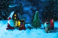 santa claus on a sleigh near the village house, it is snowing, night. New year greeting card, concept Royalty Free Stock Photo