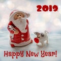 Santa Claus with a small pig - a symbol of 2019 with a congratulatory inscription Royalty Free Stock Photo