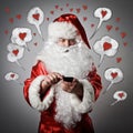 Santa Claus and smart phone. Love concept. Royalty Free Stock Photo