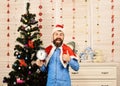 Santa Claus with smiling face near Christmas tree and garlands Royalty Free Stock Photo