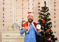 Santa Claus with smiling face near Christmas tree and garlands Royalty Free Stock Photo